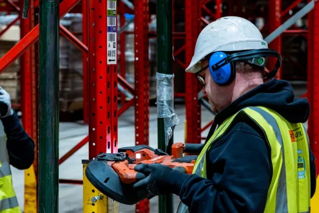 Technician performing annual racking inspection