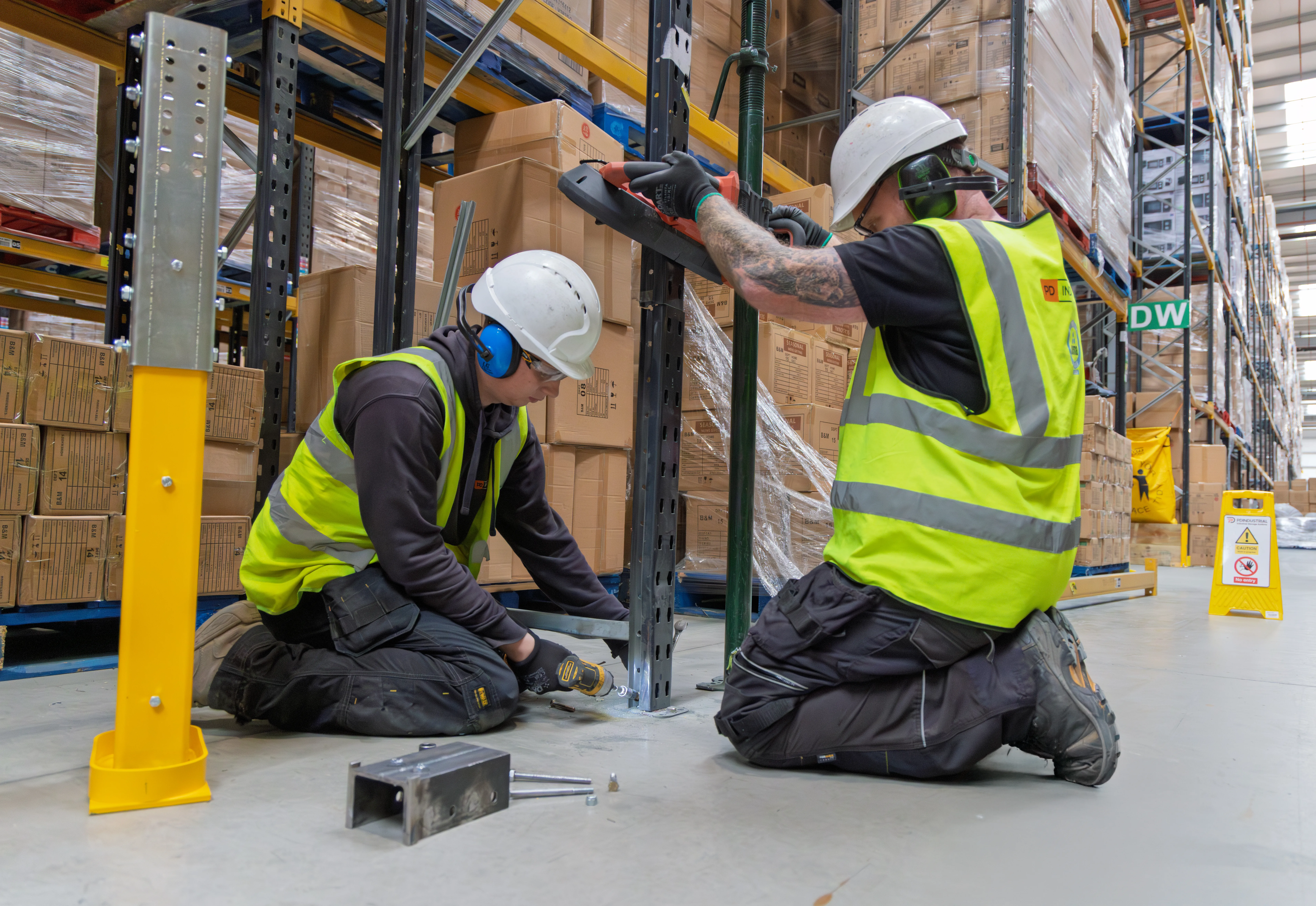 Warehouse technicians installing a racking upright repair solution